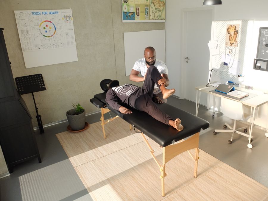 Black physiotherapist treating a Black patient